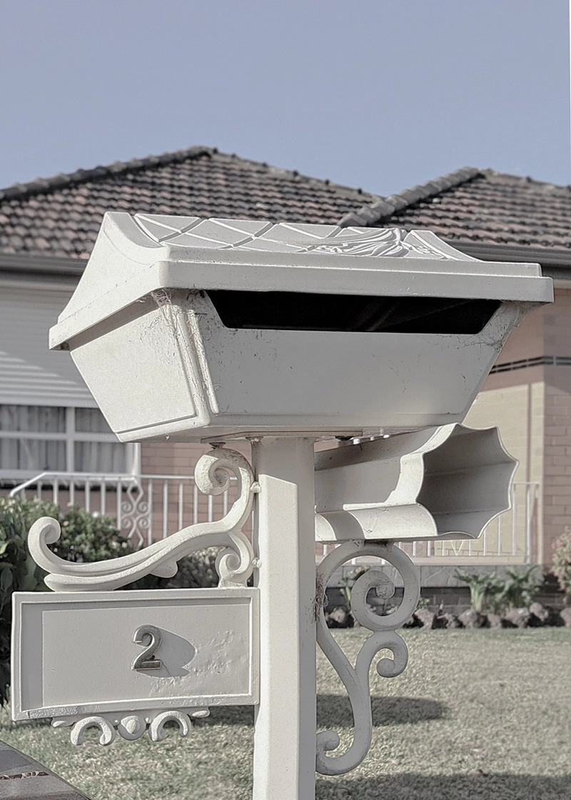Architectural portfolio image of an original letter box in front of a brick veneer post war home in Melbourne's northern suburbs.