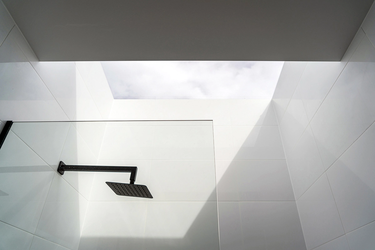 Bathroom image of an architect designed new build house. A large skylight sits over the shower.